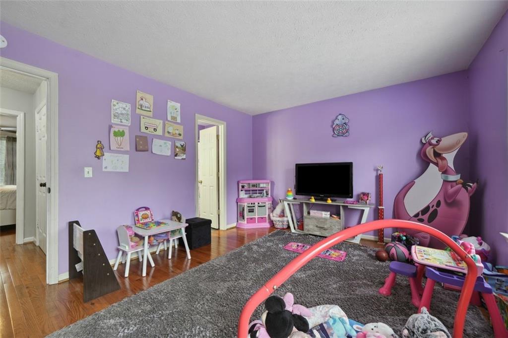 6420 Marbut Road Lithonia, GA 30058 - Photo 19 of 29 a bedroom with furniture and a flat screen tv