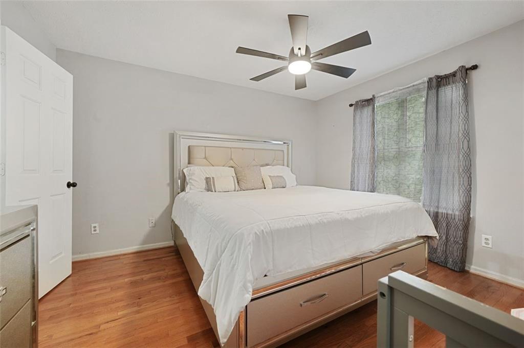 6420 Marbut Road Lithonia, GA 30058 - Photo 20 of 29 a bedroom with a bed and a chandelier