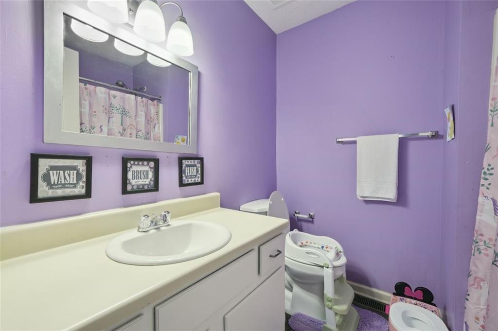 6420 Marbut Road Lithonia, GA 30058 - Photo 21 of 29 a bathroom with a sink vanity mirror and toilet
