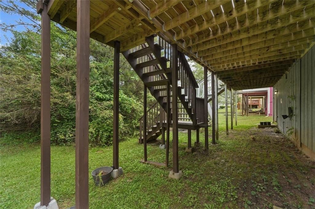 6420 Marbut Road Lithonia, GA 30058 - Photo 28 of 29 a view of an chairs under an umbrella