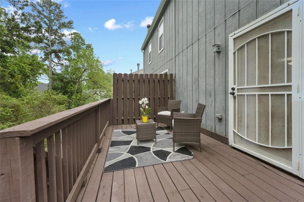 6420 Marbut Road Lithonia, GA 30058 - Photo 4 of 29 a view of balcony with chairs and wooden fence