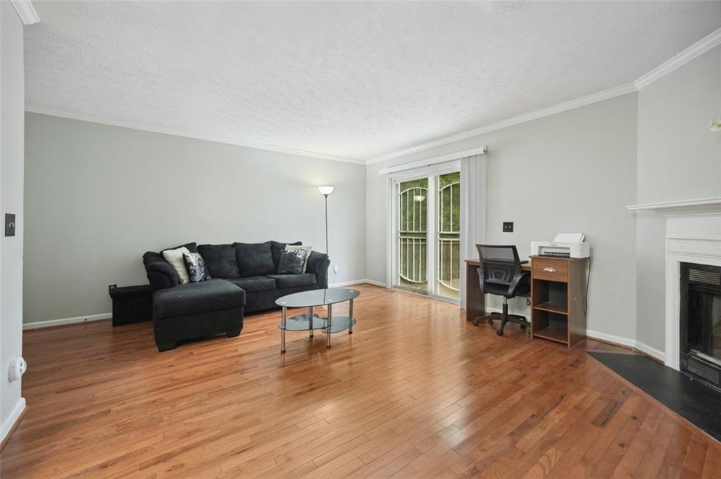 6420 Marbut Road Lithonia, GA 30058 - Photo 7 of 29 a living room with furniture and a fireplace