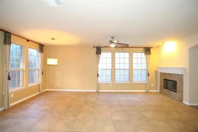 a view of an empty room with a fireplace and a window