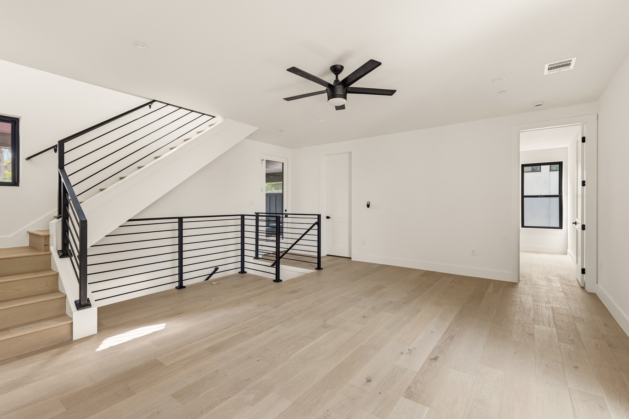2300 Bluebonnet Lane Austin, TX 78704 - Photo 20 of 40 a view of an empty room with stairs and a ceiling fan