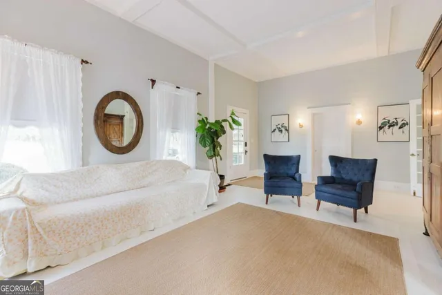 a view of a livingroom with furniture and staircase