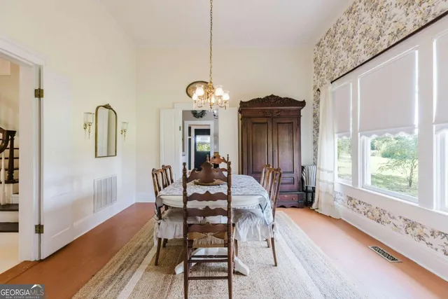 a dining room with furniture and window