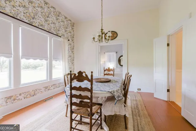 a kitchen with stainless steel appliances granite countertop a refrigerator a stove a sink dishwasher and a dining table with the view of kitchen