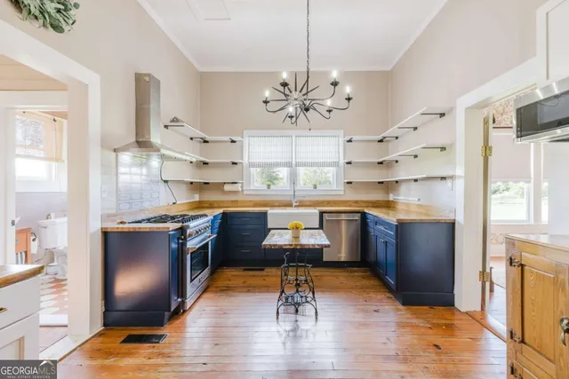 a kitchen with a table chairs sink and cabinets
