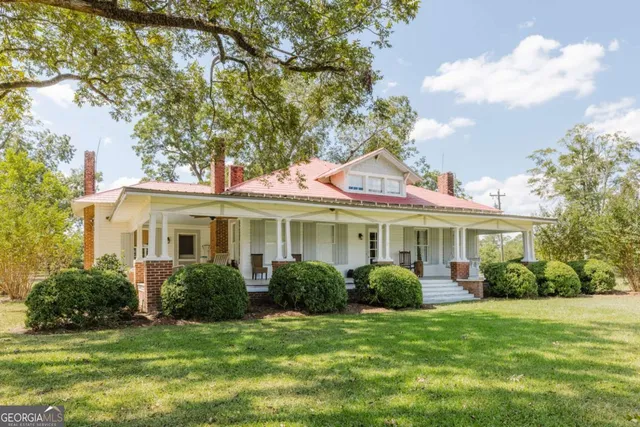 a front view of a house with a garden
