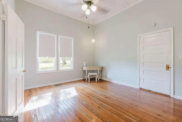 a view of a livingroom with a fireplace wooden floor and staircase