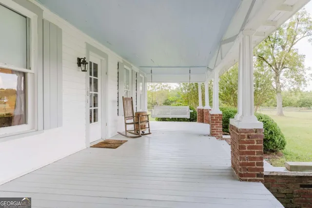 a view of a room with wooden floor and white walls