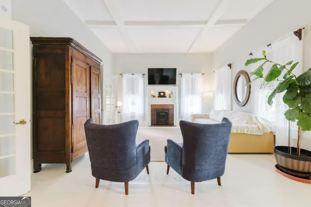 a bedroom with a bed a mirror and a window