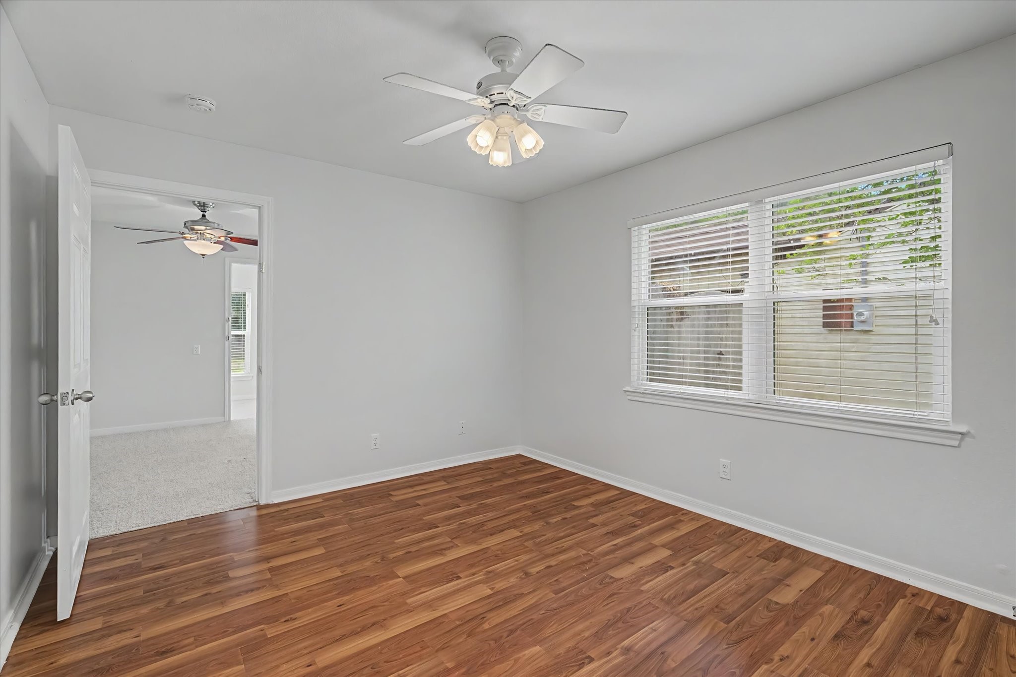 413 Farrer Street Angleton, TX 77515 - Photo 34 of 43 a view of an empty room with wooden floor and a window