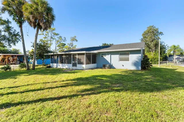 a view of a house with a backyard