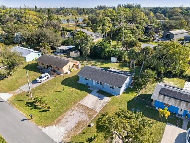 an aerial view of a house with garden space and street view