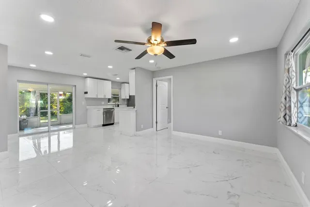 a view of a kitchen with a sink and a window