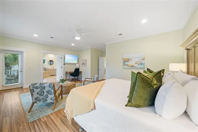 a bedroom with a bed and a potted plant