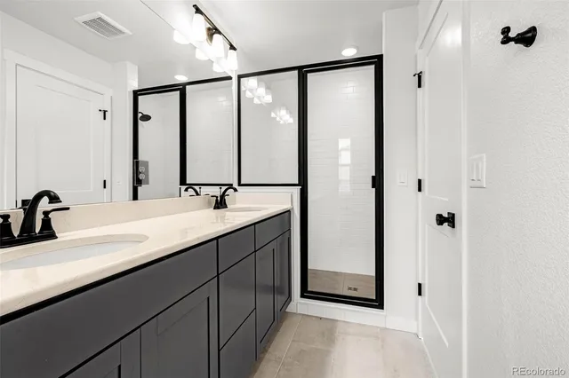 a bathroom with a double vanity sink and mirror