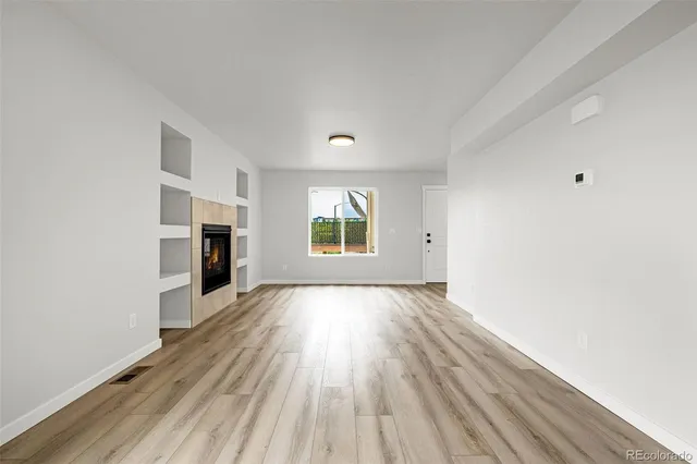 wooden floor in an empty room with a window
