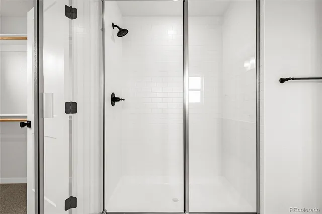 a bathroom with a granite countertop sink mirror and shower