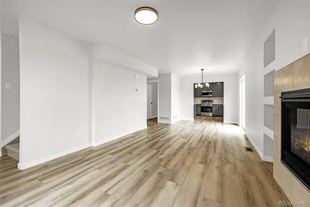 a view of empty room with a fireplace
