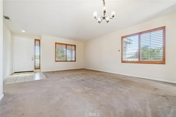 a bedroom with a bed and a refrigerator