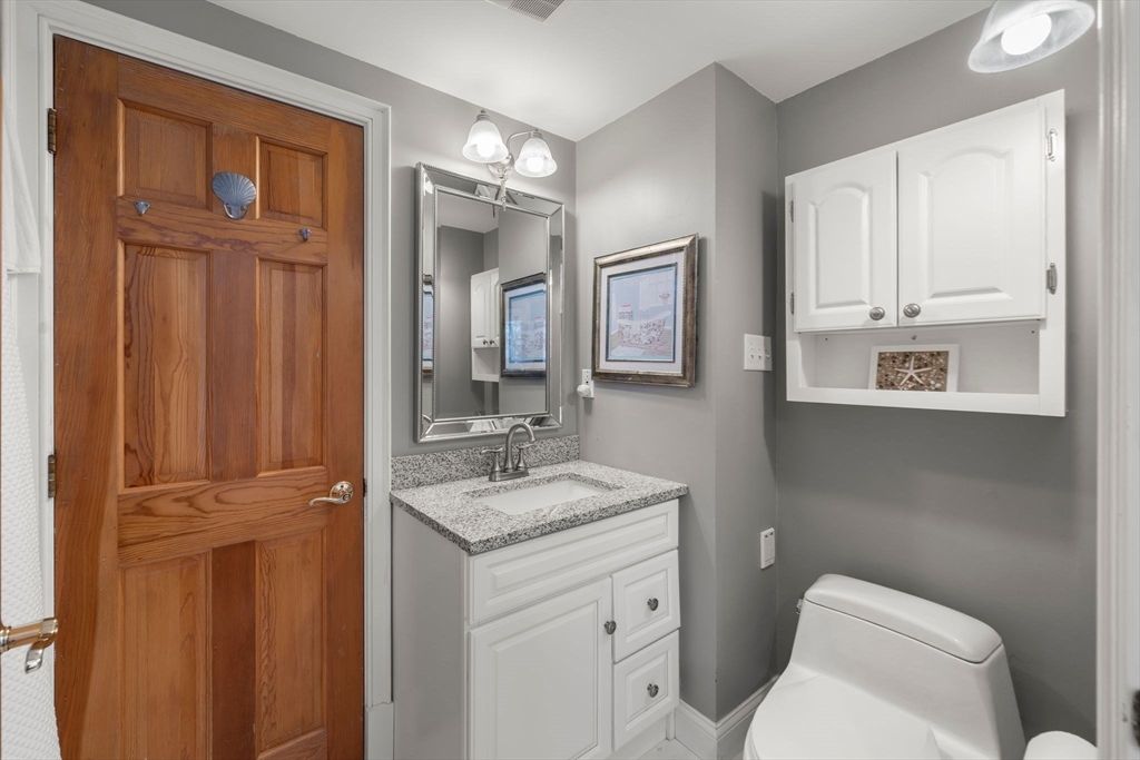 122 Clifford Road Plymouth, MA 02360 - Photo 22 of 38 a bathroom with a granite countertop sink toilet and mirror