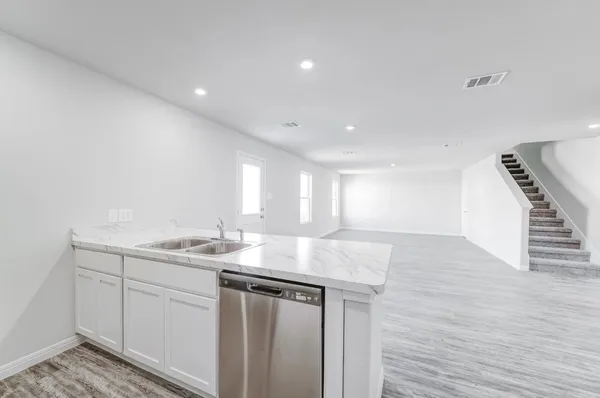 a kitchen with sink and mirror