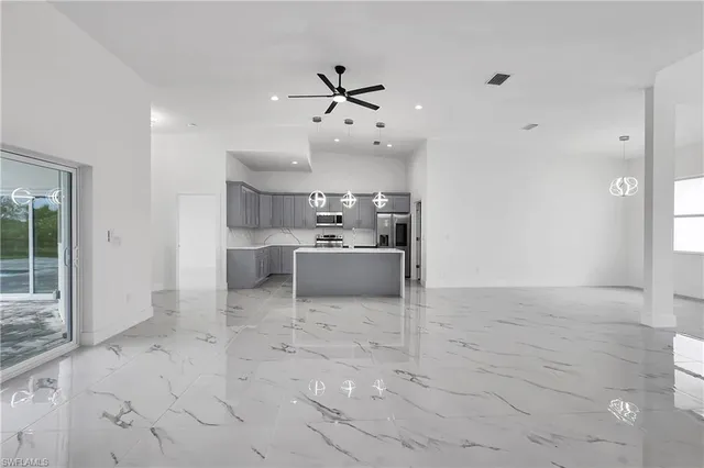 a view of a livingroom with furniture and kitchen view