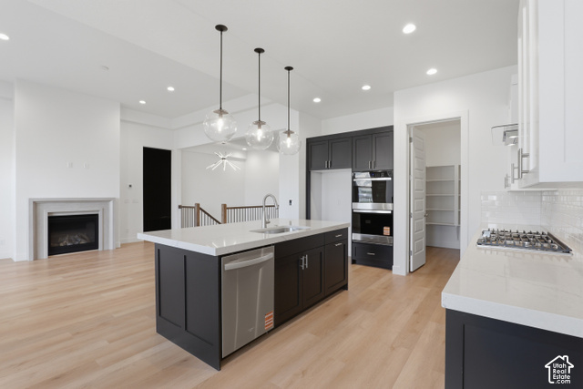 538 North Legend Circle, Unit 505 Mapleton, UT 84664 - Photo 25 of 48 Spacious kitchen featuring an expansive island, stainless steel appliances, a gas cooktop, built-in double ovens, and a walk-in pantry