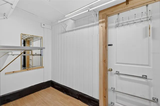 a view of a room with wooden floor and cabinet