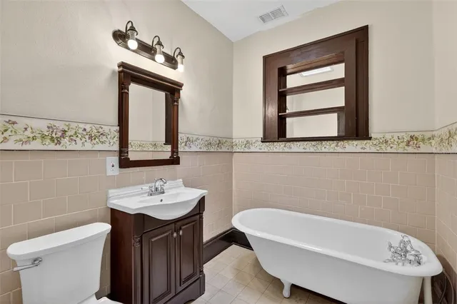 a bathroom with a sink a toilet and mirror