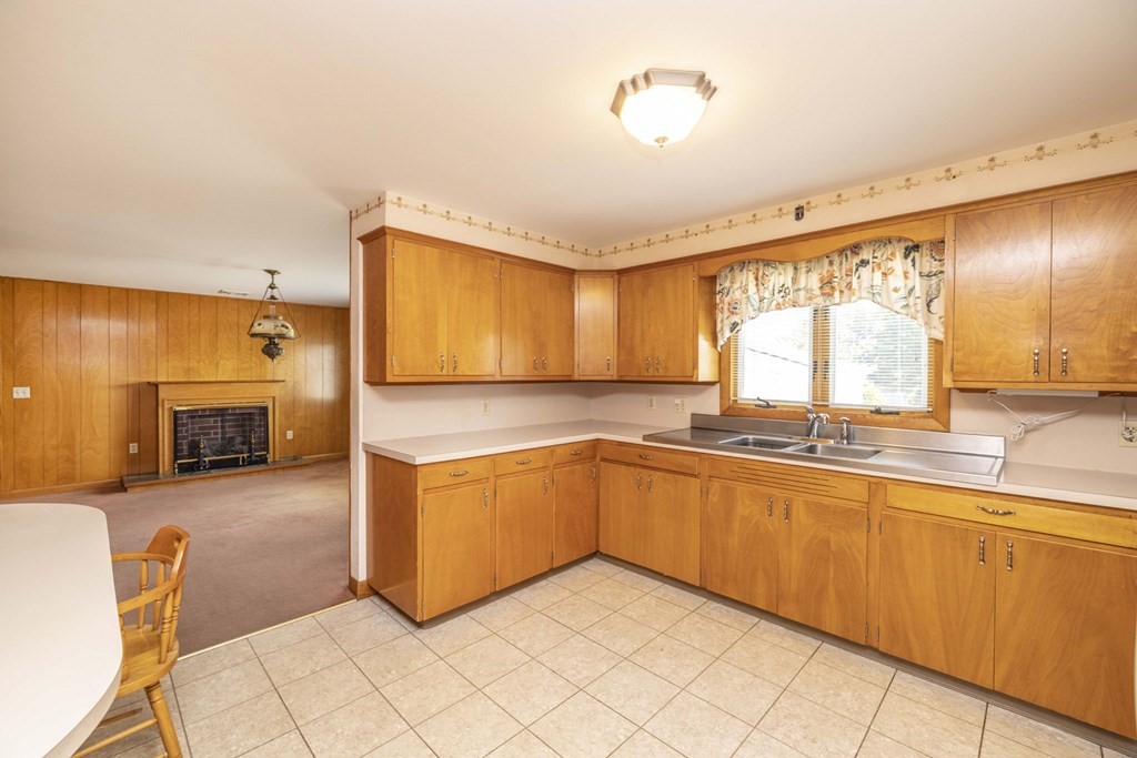 1850 Rodman Street Fall River, MA 02721 - Photo 14 of 42 a large kitchen with stainless steel appliances granite countertop a sink and cabinets
