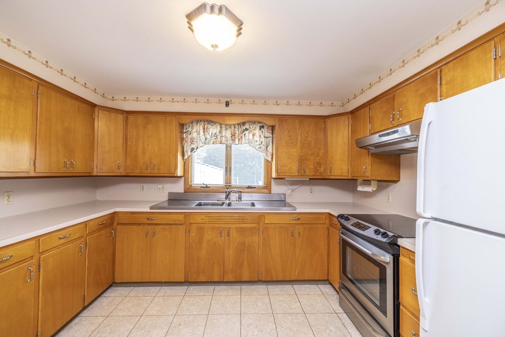1850 Rodman Street Fall River, MA 02721 - Photo 15 of 42 a kitchen with a sink stove and cabinets