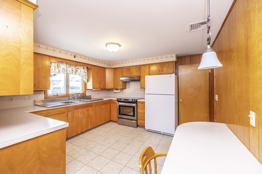 1850 Rodman Street Fall River, MA 02721 - Photo 16 of 42 a kitchen with stainless steel appliances granite countertop a stove a refrigerator and a microwave