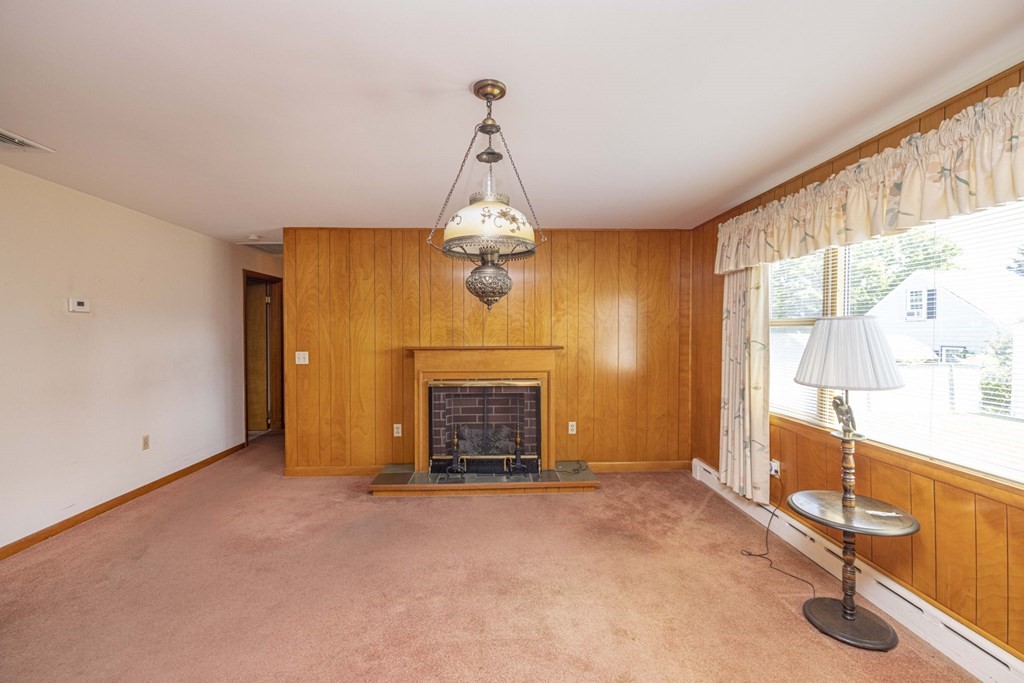 1850 Rodman Street Fall River, MA 02721 - Photo 18 of 42 a view of an empty room with a fireplace and a window