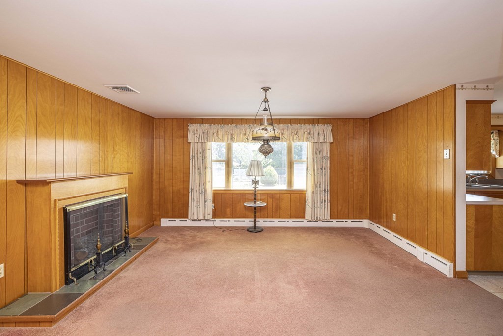 1850 Rodman Street Fall River, MA 02721 - Photo 19 of 42 a living room with fireplace furniture and a window
