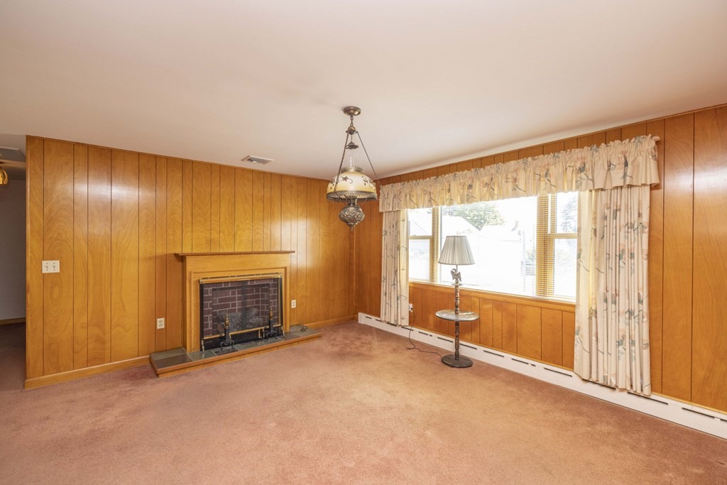 1850 Rodman Street Fall River, MA 02721 - Photo 20 of 42 a view of an empty room with a fireplace and a window