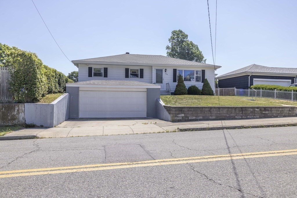 1850 Rodman Street Fall River, MA 02721 - Photo 2 of 42 a front view of a house with a garden