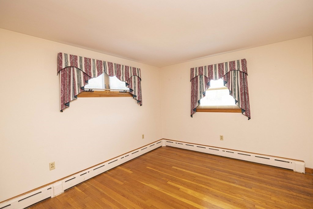1850 Rodman Street Fall River, MA 02721 - Photo 27 of 42 a view of an empty room with wooden floor and a window