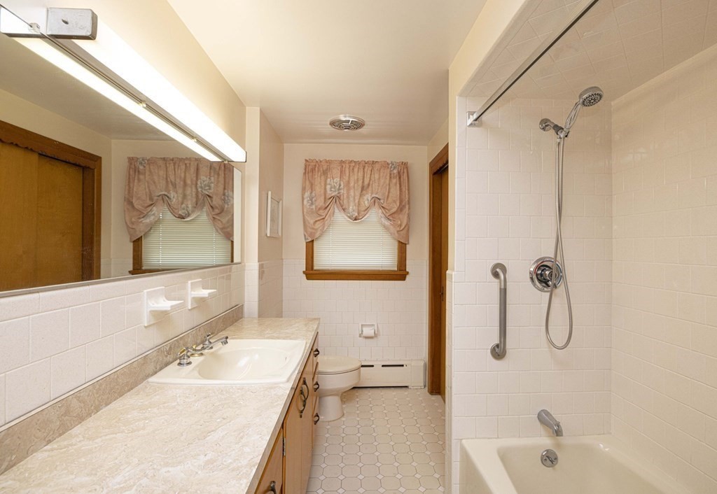 1850 Rodman Street Fall River, MA 02721 - Photo 34 of 42 a bathroom with a tub sink and mirror