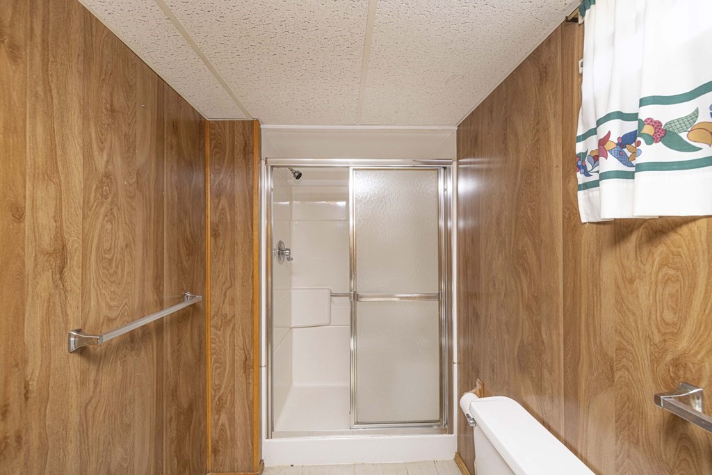 1850 Rodman Street Fall River, MA 02721 - Photo 42 of 42 a bathroom with a glass shower door and a sink