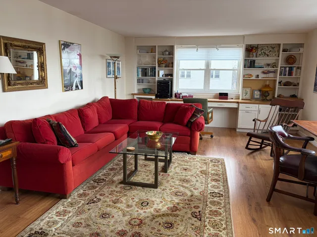 a living room with furniture fireplace and a window
