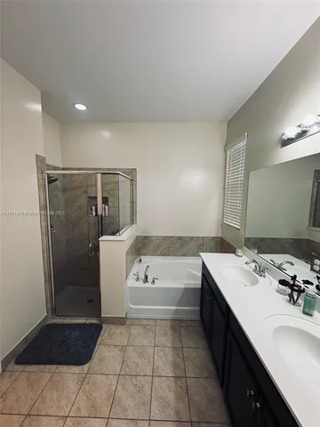 a bathroom with a tub sink and shower