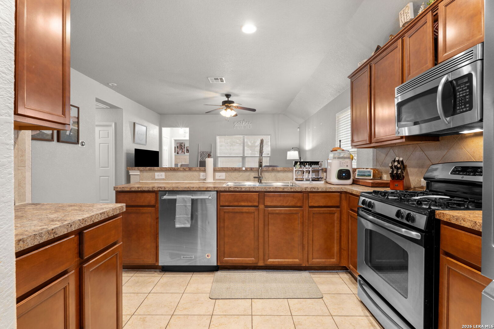 3041 Turquoise Schertz, TX 78154 - Photo 4 of 19 a kitchen with stainless steel appliances granite countertop a stove a sink and a microwave