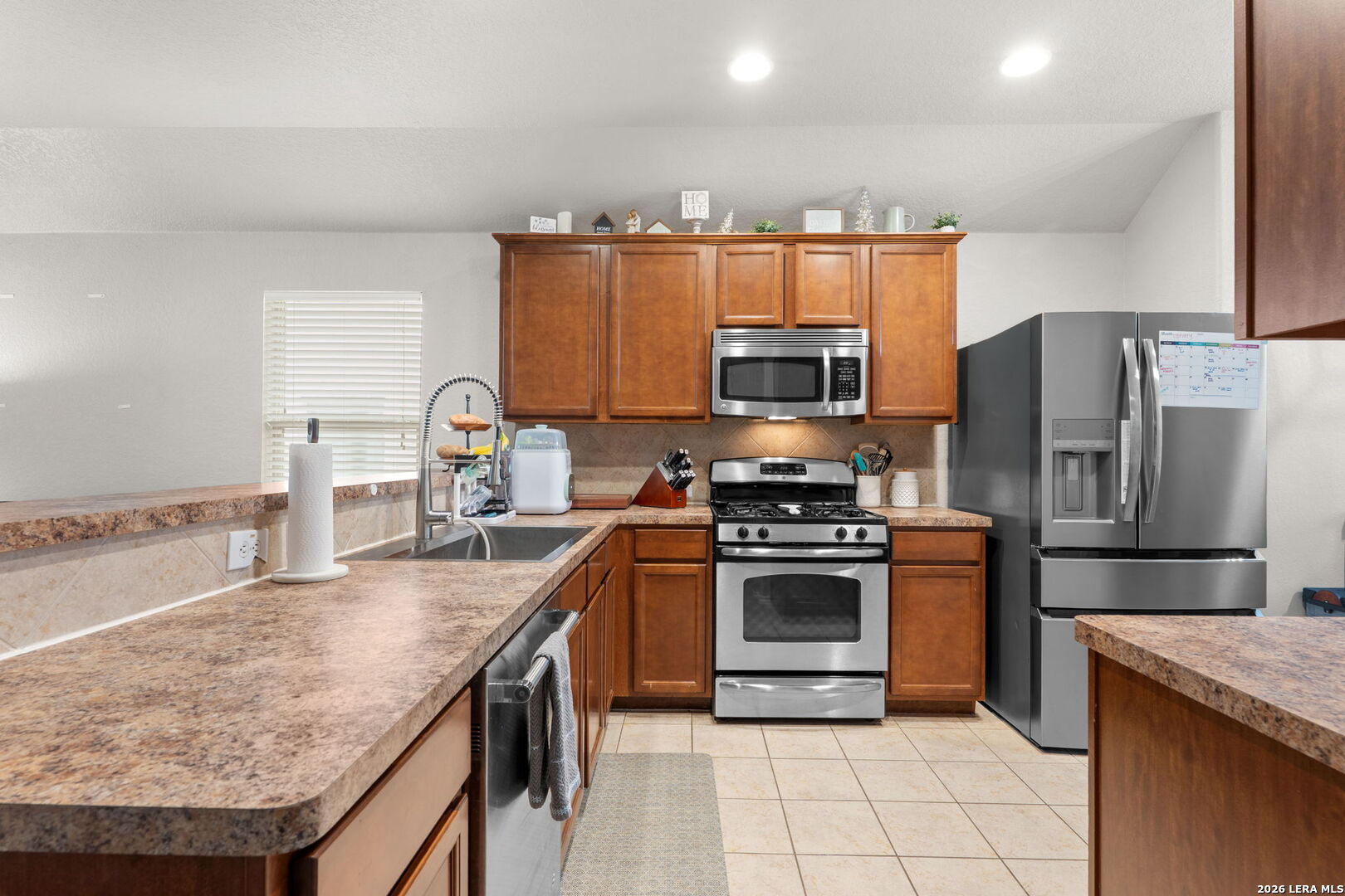 3041 Turquoise Schertz, TX 78154 - Photo 5 of 19 a kitchen with kitchen island granite countertop a stove sink and refrigerator