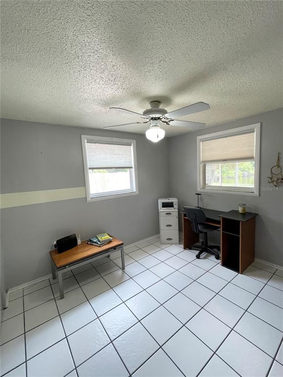 6944 Larchmont Avenue New Port Richey, FL 34653 - Photo 14 of 28 a living room with a furniture and a window
