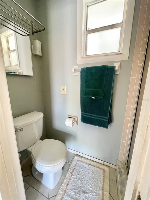6944 Larchmont Avenue New Port Richey, FL 34653 - Photo 16 of 28 a bathroom with a toilet a sink and a window