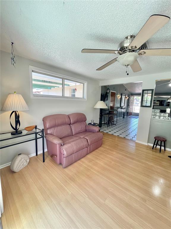 6944 Larchmont Avenue New Port Richey, FL 34653 - Photo 19 of 28 a living room with furniture and a wooden floor