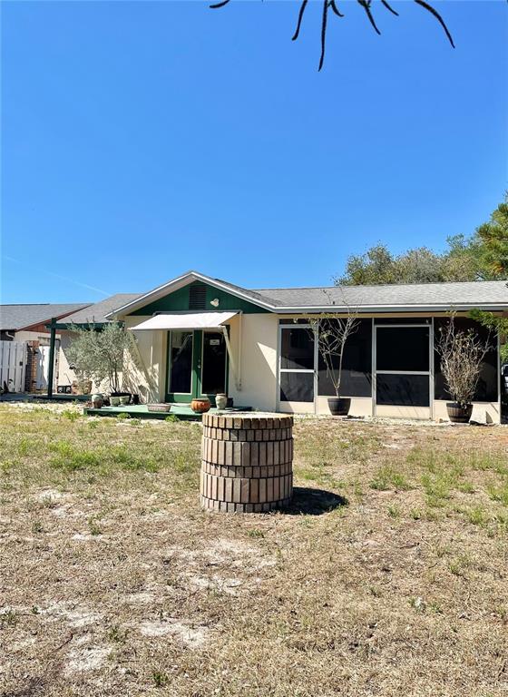6944 Larchmont Avenue New Port Richey, FL 34653 - Photo 25 of 28 a front view of a house with a yard